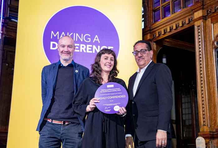 Annie Carpenter and Andrew Wilson from para-lab on stage receiving their Making a Difference award from University of Manchester Chancellor Nazir Afzal.